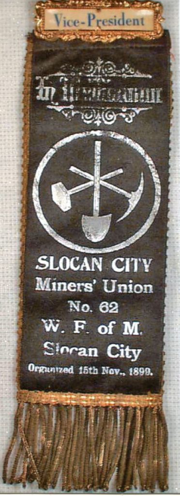 The Slocan City Miners' Union was organized in 1899. The insignia shows a pick, shovel and hammer.