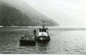 The "Oyen" tugboat towing the biggest log boom to Slocan City for the Jennings sawmill. c.1927/8
